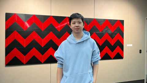 Rex Gao in front of painting