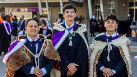 Three Maori students in graduation regalia