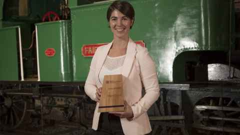 Megan holding an award