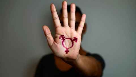 A transgender symbol drawn on a hand.