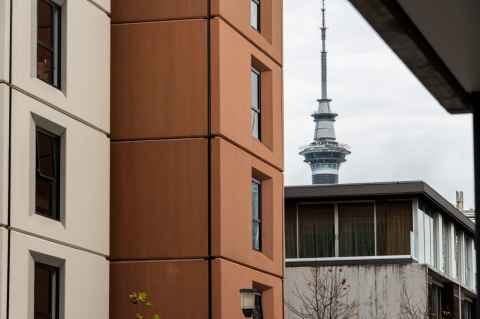 View of the top of the Sky Tower between Carlaw Park - Nicholls buildings 