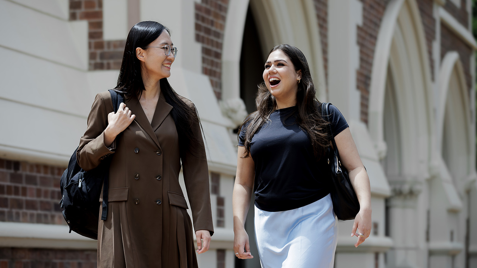 Two students walking outside the high court.