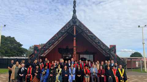 Nic Smith and others gather outside Ōrākei Marae.
