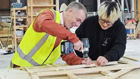 Gary Raftery and Ziyang Zhou drilling wooden structures during the international student bridge competition