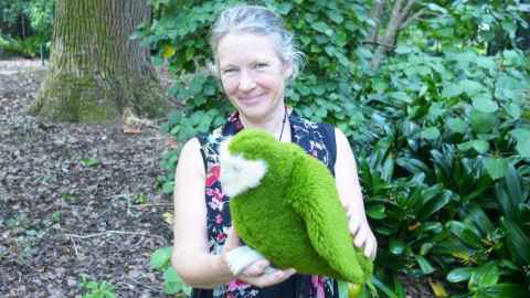 Professor Jacqueline Beggs with a soft toy kākāpō.