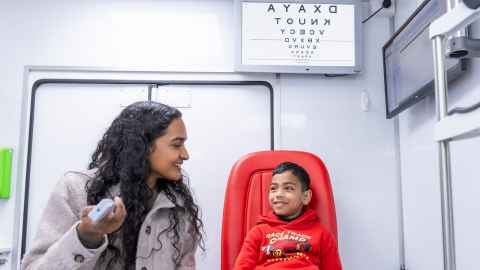 A child and optometry student on the vision bus