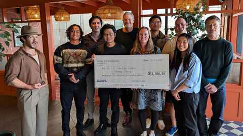 The University of Auckland’s Enterprise AI team holding an oversized cheque