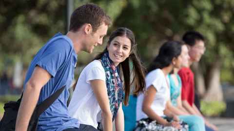 Students sitting together outside
