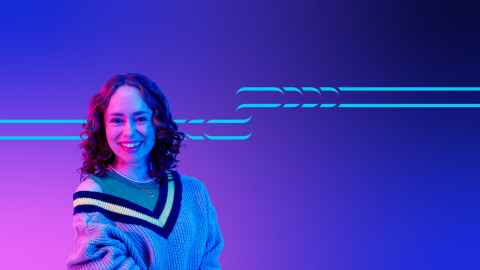 Student standing against a pink and blue background.