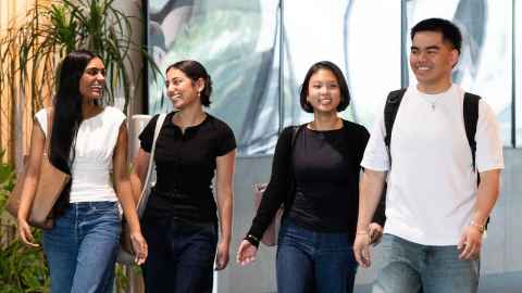 Group of smiling students walking inside