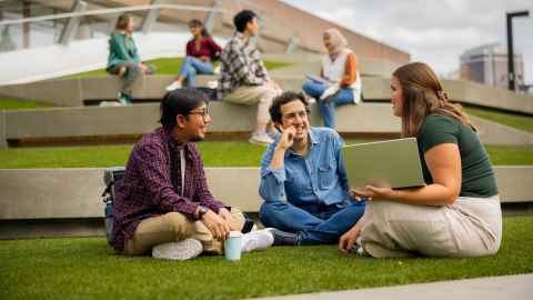Students sitting together outside.