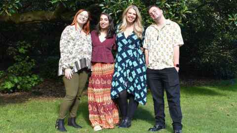 Four members of the Student Equity team smiling at the camera while posing for a group photo.