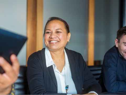 Pacific woman in a meeting smiling