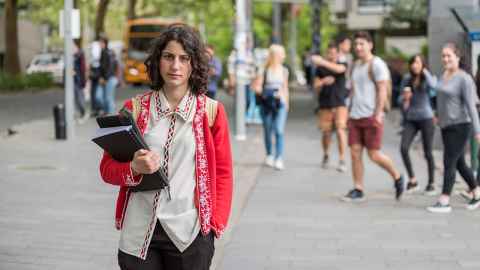 Woman standing with textbooks