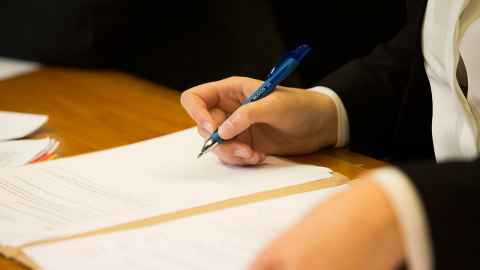 person writing on paper