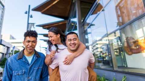 Three young Pacifica people walking and laughing