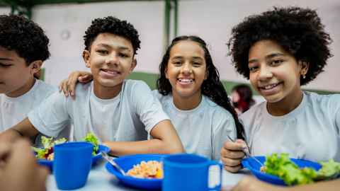 A small group of school children during lunch in the school cafeteria, Brazil