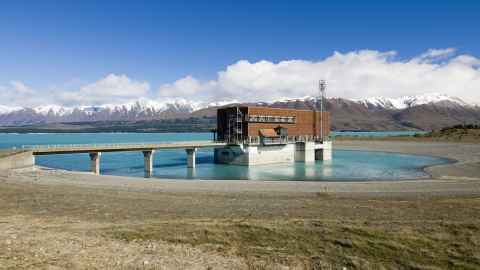 The Tekapo B hydro power station on Lake Pukaki, glacier water, low lake level, South Island, New Zealand.