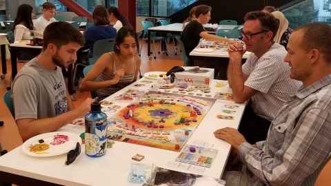 Students and staff playing a sustainability game in the SUSTAIN 100/100G course