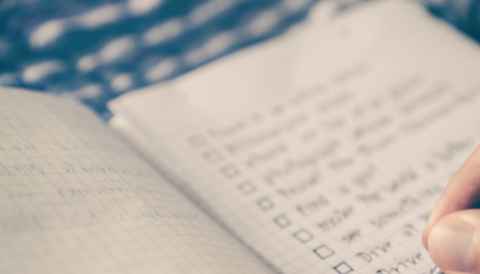 Handwritten checklist in a notebook