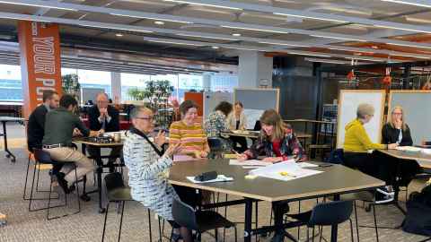 People working in groups at tables