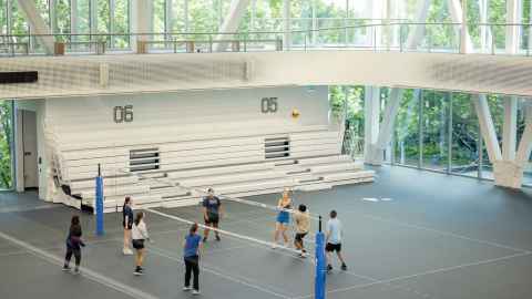 Students playing volleyball inside Hiwa, the University's sports and recreation centre on its City Campus