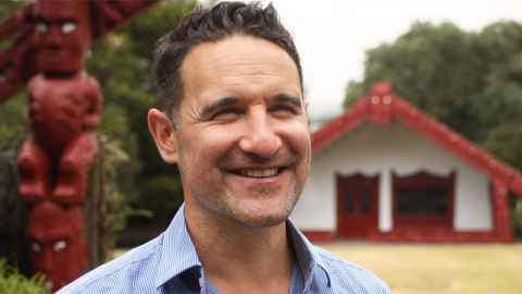 A smiling man on a marae.