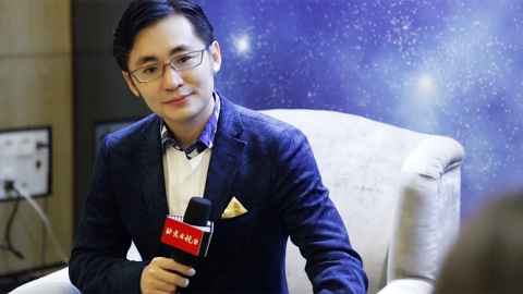 A well-dressed young man with a microphone.