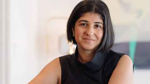 A woman with her dark hair styled in an asymmetric bob, wearing black.