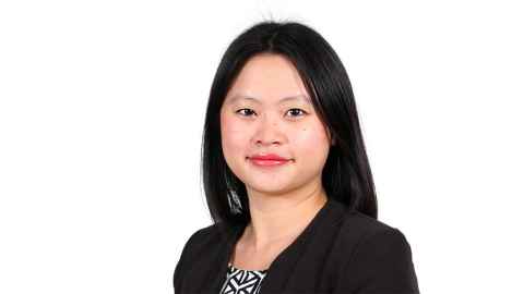 A woman with black hair, wearing a black jacket.