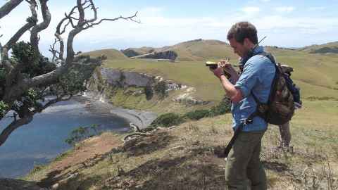 Image of researcher taking photo in a field