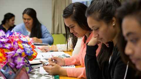 Māori and pacific postgraduate students studying together in a study area.