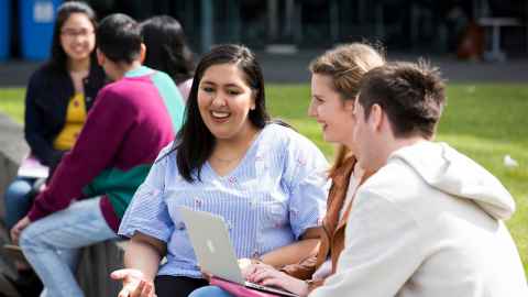 Students talking outside building