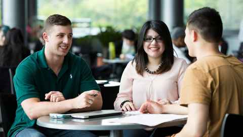 Three students at a table