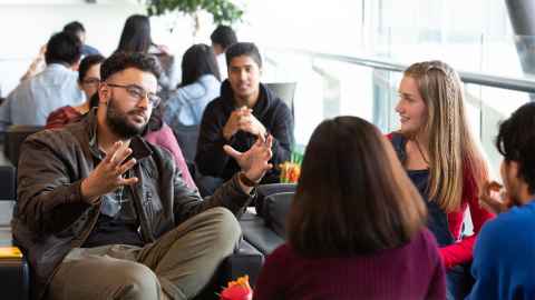 Group of students sitting at table indoors