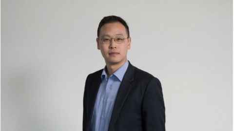 A young man wearing glasses