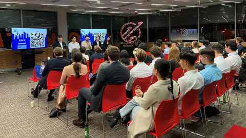 An attentive audience listens as five panellists share their insights