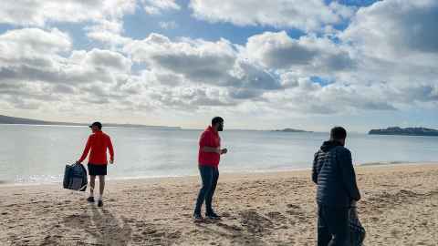 People helping to clean up rubbish from Mission Bay.