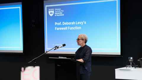 A woman speaking at a lectern
