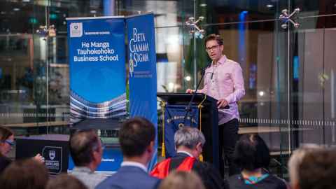 Matty Blomfield speaks to attendees of Beta Gamma Sigma ceremony