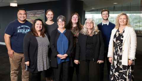 Eight team members of the Student Development and Engagement team facing the camera and smiling.