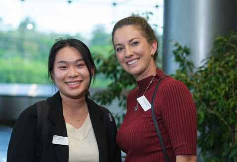 Image of two women standing next to each other smiling.