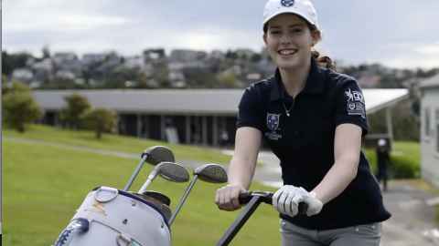Student golfer with golf club trolley