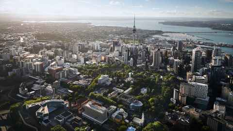 Auckland City from above, with the University campus in the foreground and the city and harbour in the background.