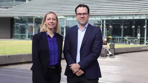 A man and woman standing in front of a building.