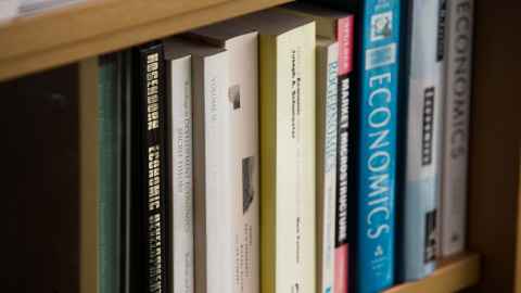 Economics books on a shelf.
