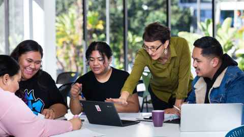 students brainstorming with academic at Tai Tonga Campus