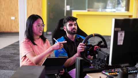 Engineering students in F-SAE racecar simulator at Newmarket Campus