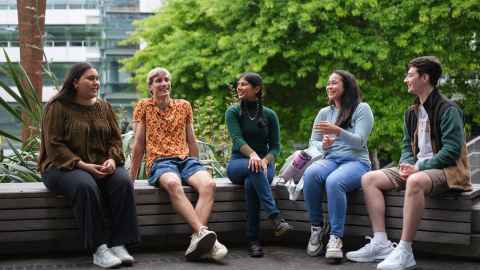 Students sitting together in the courtyard chatting