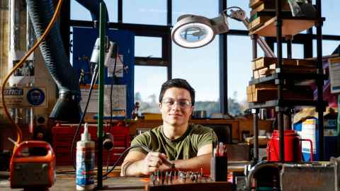Logan Bow soldering at his workbench